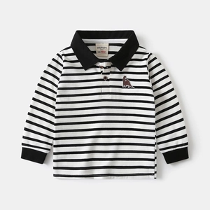 Detailed view of striped children's polo shirt with dinosaur embroidery and ribbed cuffs