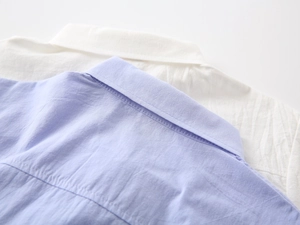 Close-up of the collar and breathable cotton linen texture on boys short sleeve shirts