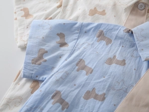 Detail of boys' cotton shirts showing soft horse prints and woven fabric texture