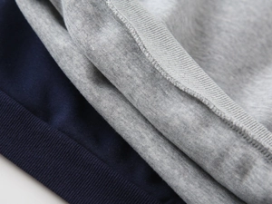 Detailed macro view of navy blue ribbed cuffs and soft fleece lining on a boys' sweatshirt