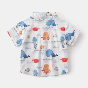 Detail of boys short-sleeved shirt with colorful cartoon marine life prints on white fabric