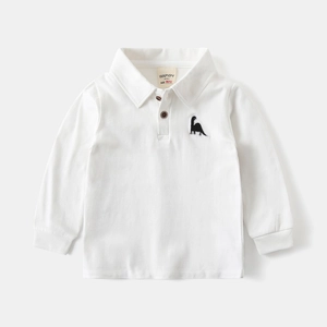 Close-up of white knit cotton kids polo shirt featuring a small dinosaur embroidery