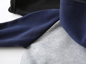 Close-up of contrast color stitching and soft cotton fabric on kids hooded jacket