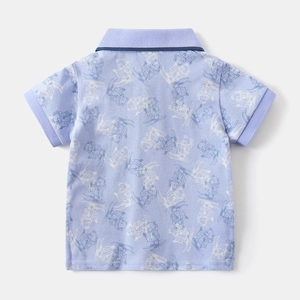 Detail view of boys lilac piqué polo shirt with all-over skiing bear cartoon print