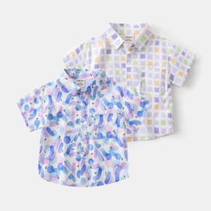 Detail showing flat lay of boys cotton beach shirts with vibrant prints and button collar