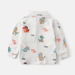 Detail of boys long sleeve polo shirt showing colorful dinosaur prints and ribbed cuffs