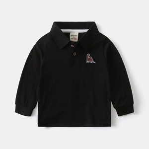 Detail of kids polo shirt featuring dinosaur embroidery and ribbed cuffs on black cotton