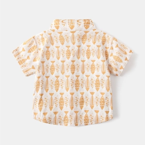 Detail view of boys short-sleeve shirt back with yellow fishbone print on white cotton