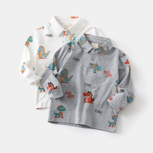 Close-up of boys' cotton polo shirts with colorful dinosaur prints and three-button collar