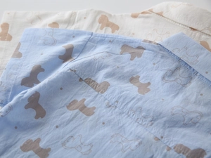 Detail of boys' short sleeve shirts with pony print and cotton fabric texture