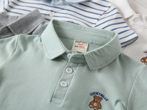 Detailed view of Lucky Bear embroidery and collar branding on boys' cotton polo shirts