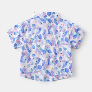 Close-up of boys' beach style shirt with blue and purple watercolor geometric print