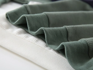 Detail shot of the ribbed knit fabric texture on boys' raglan sleeve sweatshirts