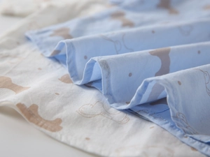 Macro shot of cotton blend fabric with cute dog prints and polka dots for boys shirts