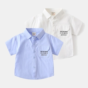 Close-up of boys short-sleeve shirts in light blue and white with printed chest pockets