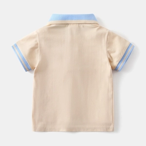 Detail of baby polo shirt with contrasting blue collar and ribbed striped cuffs