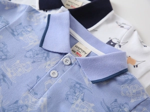 Close-up of kids polo shirt collar featuring bear prints and breathable cotton fabric