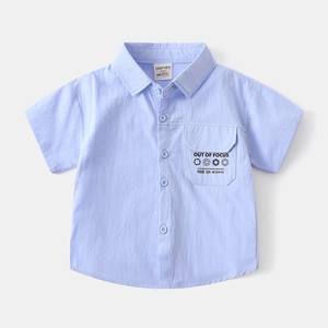 Macro detail of toddler shirt chest pocket with stylish graphic print and button