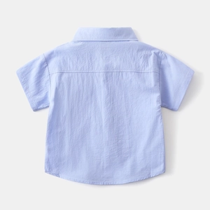Detail view of light blue boys short-sleeve shirt showing breathable crinkle fabric texture