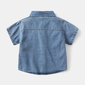 Back view of boys' short sleeve denim shirt in light blue wash with seam detail