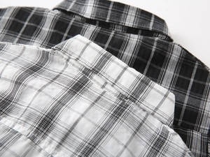 Detail shot of the collar and shoulder seams of a plaid shirt with precise stitching