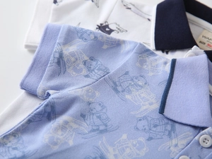 Close-up of polo shirts for boys featuring bear patterns and breathable pique fabric texture