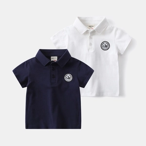 Detail of cotton polo shirts showing embroidered chest badges and classic ribbed collars