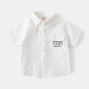 Detail of white cotton boy shirt pocket featuring black text and camera icon design