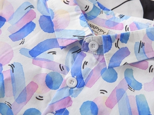 Detail of boys' summer shirt showing the crisp collar, white buttons and watercolor print