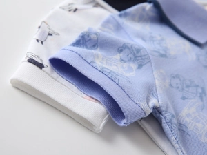 Detailed macro view of piqué cotton fabric and ribbed cuff on a cartoon bear polo shirt