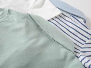 Macro detail of high-quality double-needle stitching on cotton polo shirt shoulders