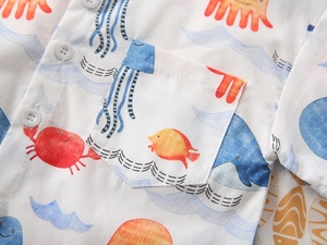 Close-up of boys' short-sleeved shirt with colorful marine life print and pocket