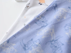 Close-up of boys piqué cotton polo shirt showing breathable honeycomb fabric texture