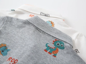Detail of the high-quality stitching on the collar and the dinosaur prints on the cotton polo shirt