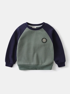Boys raglan sleeve sweatshirt in green waffle knit fabric with vintage sports aesthetic