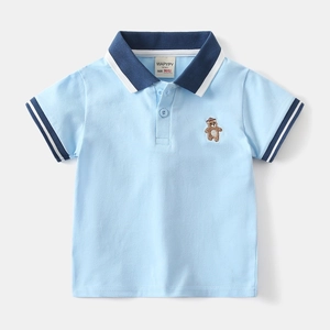 Detail shot of baby boy polo shirt featuring blue collar stripes and bear embroidery