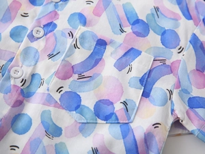 Detail of boys' beach shirt with colorful watercolor dots and front chest pocket