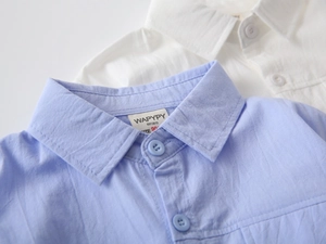 Detail showing breathable cotton fabric texture and classic collar of boys' shirts