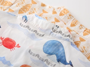 Detail of boys' short sleeve shirts featuring cartoon whale and crab marine prints