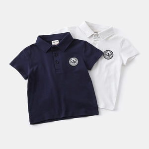 Detail view of boys cotton polo shirts with embroidered outdoor mountain chest patches