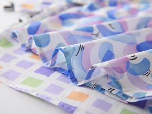 Macro view of digital print fabric with abstract artistic patterns on boys summer shirt