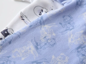 Close-up of breathable mesh fabric on baby polo shirts with cartoon animal prints