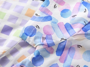 Detailed close-up of vibrant abstract digital print and premium stitching on boy's shirt