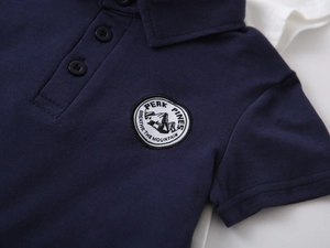 Detail of navy boy's Polo shirt with Peak Pines mountain embroidered patch and collar