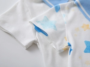 Detail of star-print polo shirt showing blue striped collar and needlework on sleeve