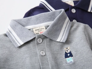 Detail of embroidered bear and striped collar on cotton polo shirts for boys