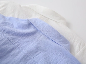 Close-up of boys' crinkle cotton linen shirts showing fine stitching and collar detail