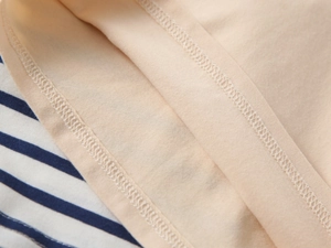 Detail of premium striped polo shirt showing reinforced seams and soft lining