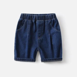 Detail of elastic waistband and stitching on boys' dark blue denim shorts