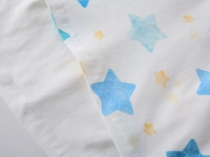 Detailed macro view of star pattern print and double-stitched hem on cotton polo shirt
